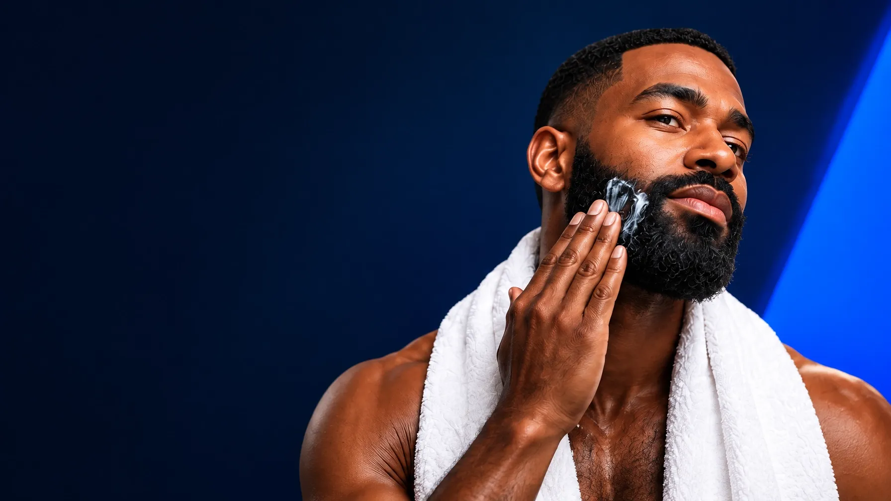 A man applying beard care as part of his grooming routine